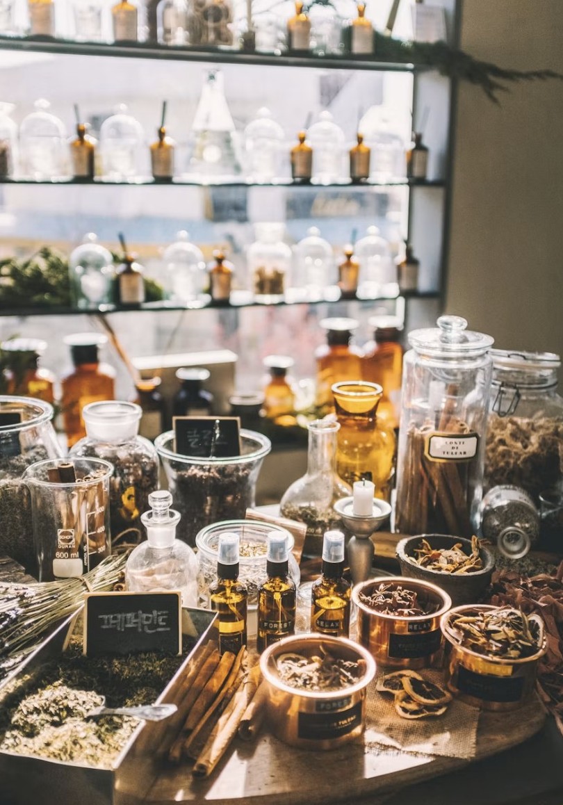 Natural remedies with dried herbs and amber apothecary bottles in soft window light